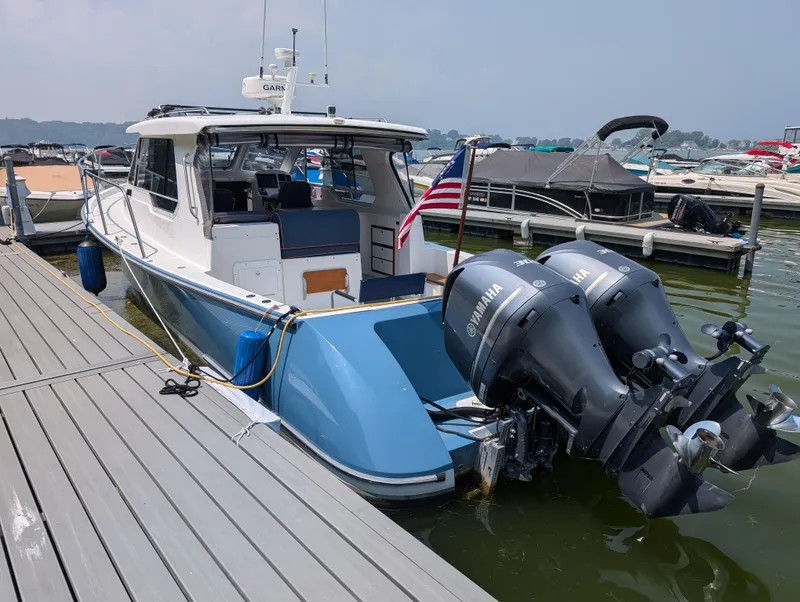 Slide: The Image of 2018 True North 34OE boat docked with twin Yamaha outboard motors. - 6