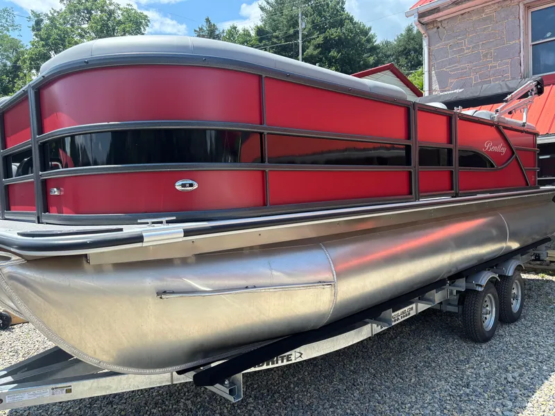 The Image of 2025 Bentley Pontoons 223 NAVIGATOR, red exterior, on trailer, parked outdoors. - 1