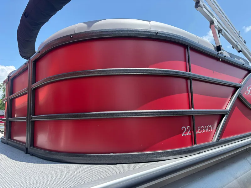 Slide: The Image of 2025 Bentley Pontoons 223 NAVIGATOR, red exterior, close-up view under blue sky. - 4