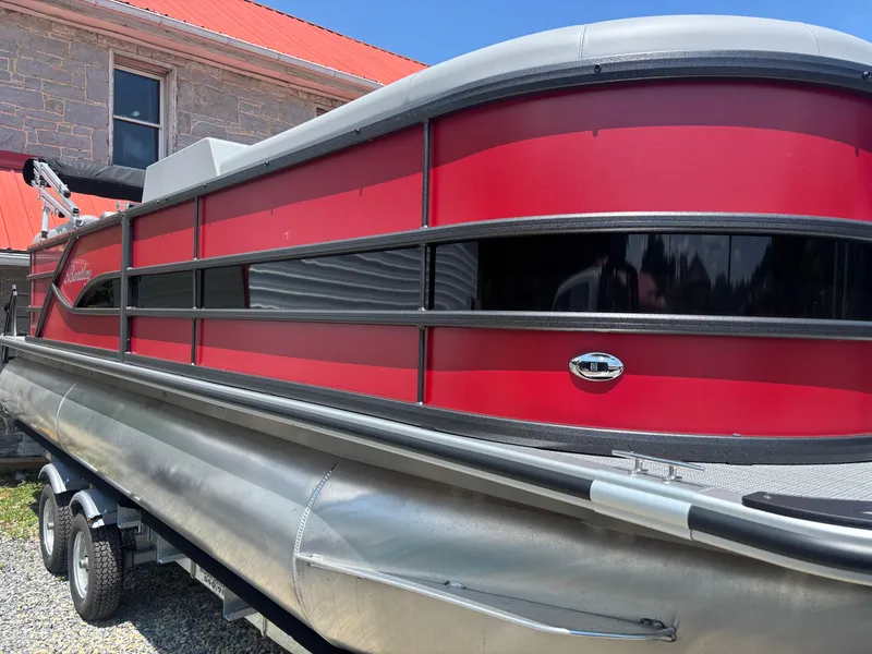 Slide: The Image of 2025 Bentley Pontoons 223 NAVIGATOR, red exterior, parked on trailer, near stone building. - 6
