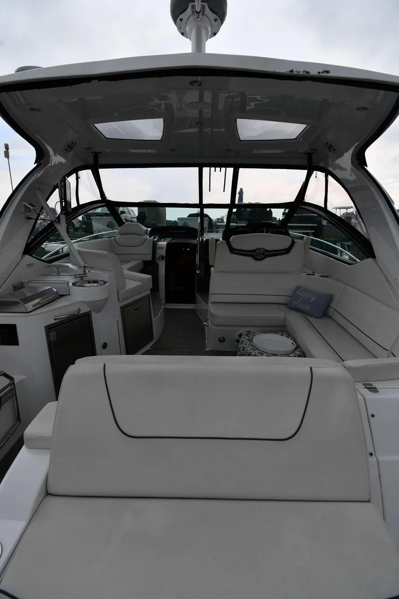Slide: The Image of 2019 Cruisers Yachts 380 Express interior with seating and helm, showcasing luxury design. - 10