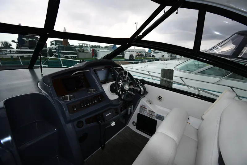 Slide: The Image of 2019 Cruisers Yachts 380 Express cockpit with steering wheel and dashboard controls. - 12