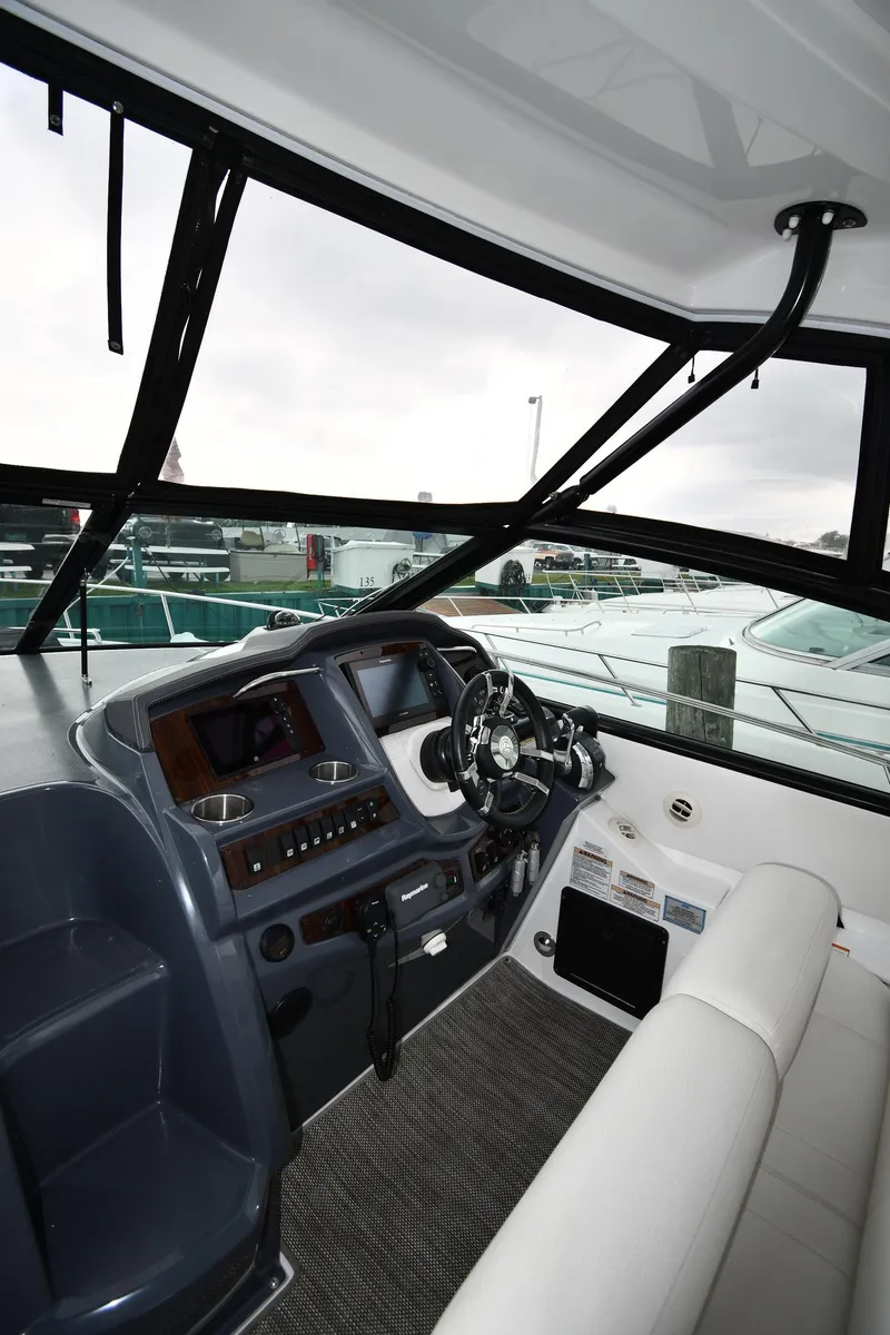 Slide: The Image of 2019 Cruisers Yachts 380 Express helm with modern controls and comfortable seating. - 13