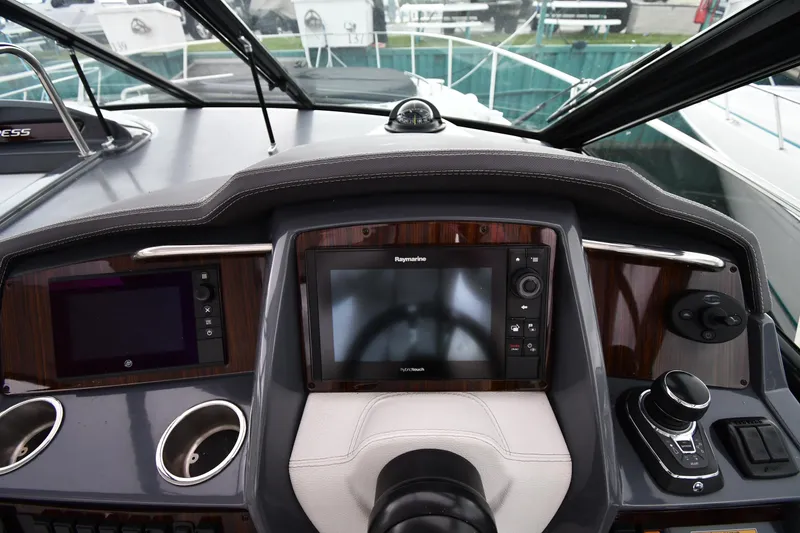 Slide: The Image of 2019 Cruisers Yachts 380 Express helm with advanced navigation controls and displays. - 14