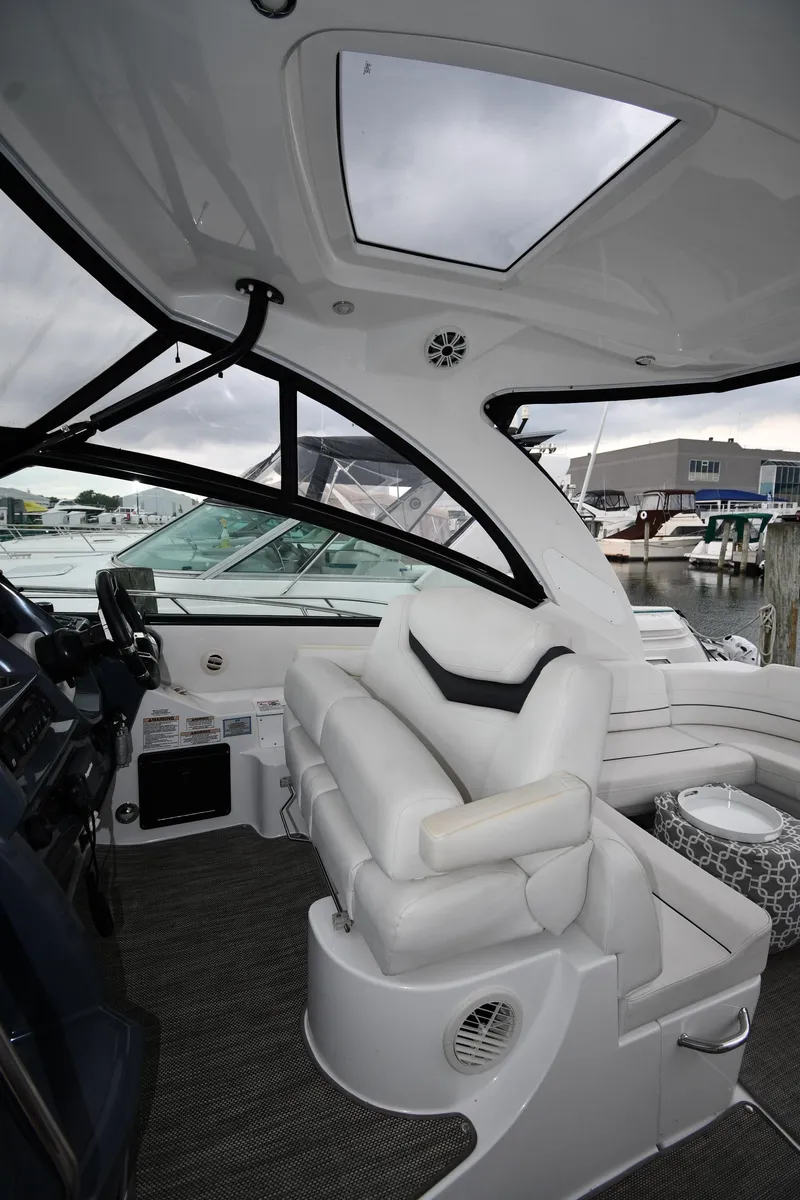 Slide: The Image of 2019 Cruisers Yachts 380 Express interior with plush seating and panoramic windows. - 17