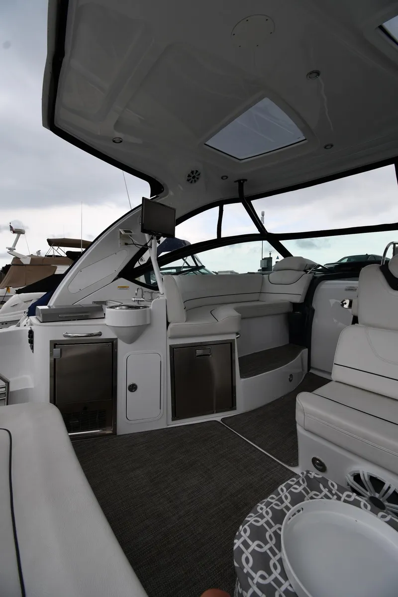 Slide: The Image of 2019 Cruisers Yachts 380 Express interior with modern seating and sleek design. - 21