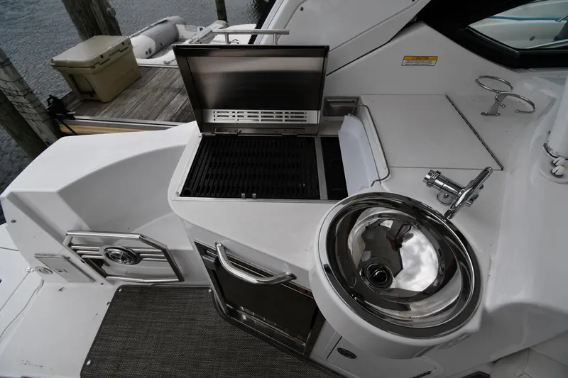 Slide: The Image of Outdoor kitchen on 2019 Cruisers Yachts 380 Express with grill and sink. - 24