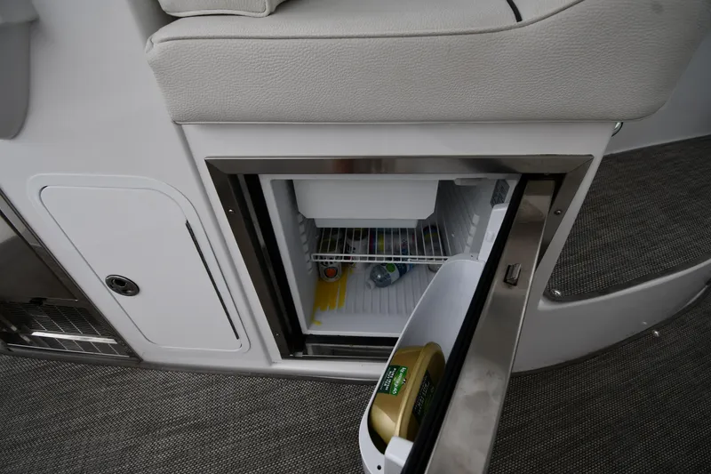 Slide: The Image of 2019 Cruisers Yachts 380 Express interior fridge with open door, showing contents. - 26