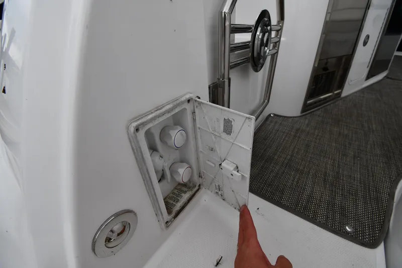 Slide: The Image of 2019 Cruisers Yachts 380 Express interior detail with open panel and controls. - 28