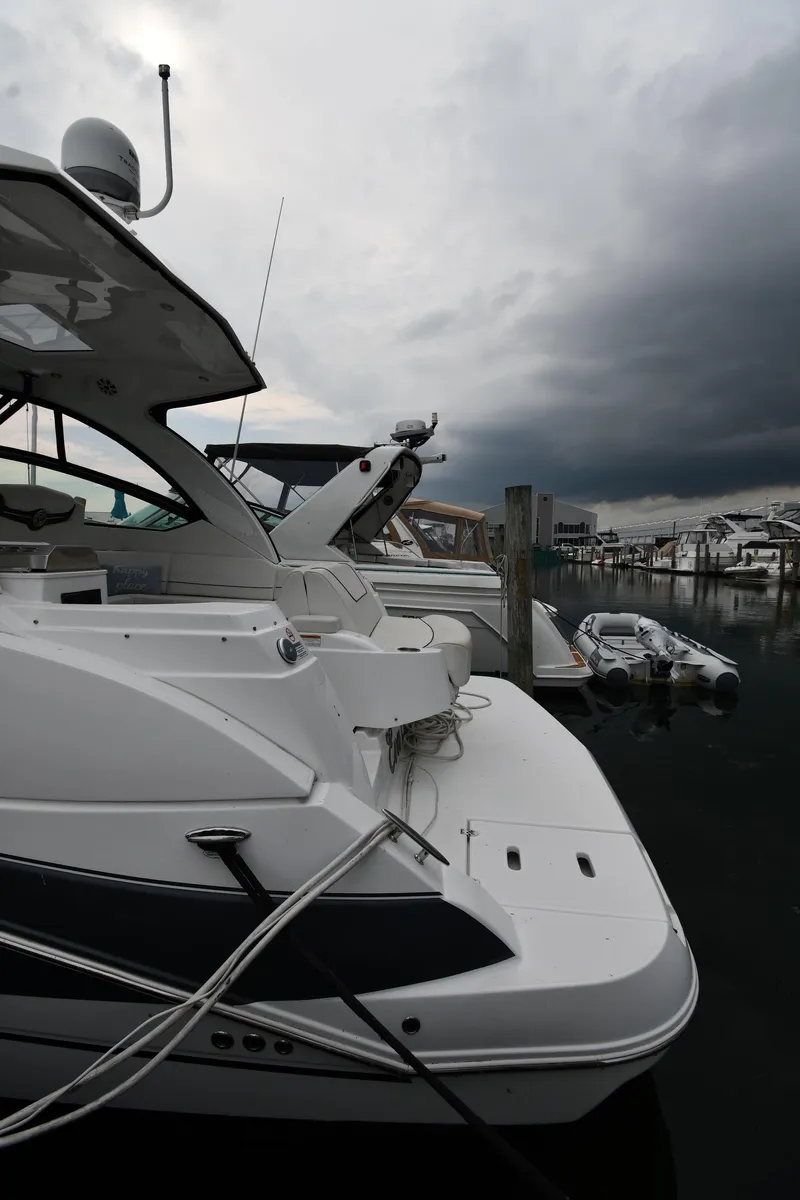 Slide: The Image of 2019 Cruisers Yachts 380 Express docked under cloudy skies. - 3