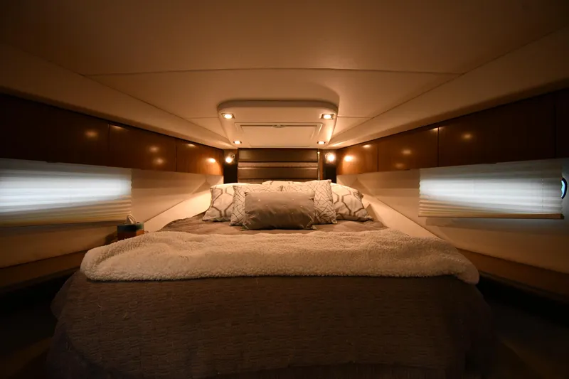 Slide: The Image of Luxurious cabin interior of 2019 Cruisers Yachts 380 Express with cozy bedding. - 32