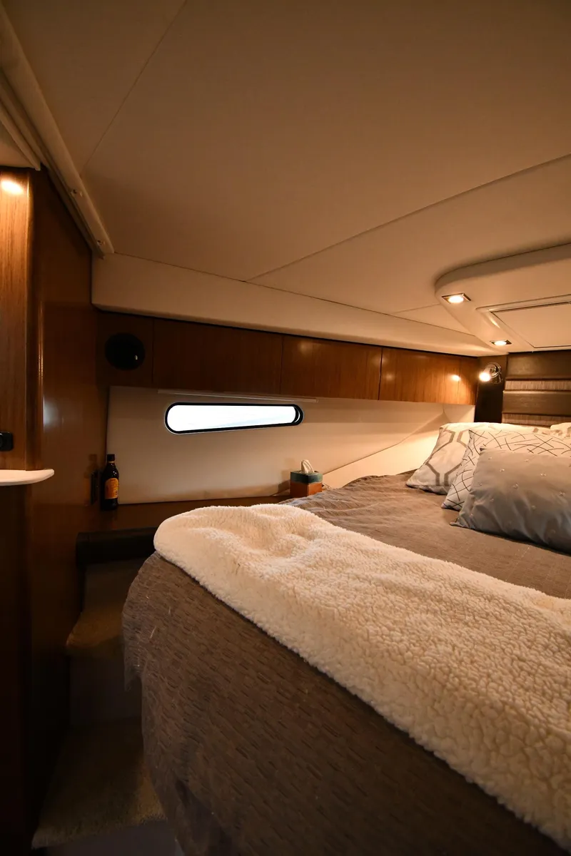 Slide: The Image of Luxurious cabin interior of 2019 Cruisers Yachts 380 Express with cozy bedding. - 34