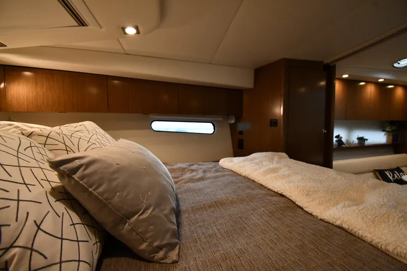 Slide: The Image of Luxurious cabin interior of 2019 Cruisers Yachts 380 Express with cozy bedding. - 36