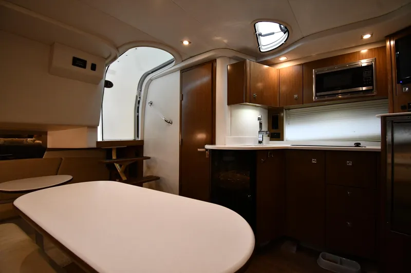 Slide: The Image of 2019 Cruisers Yachts 380 Express interior with modern kitchen and dining area. - 42