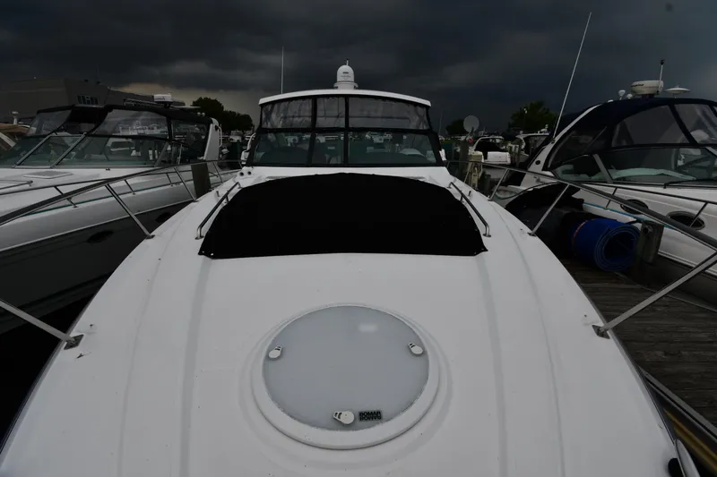 Slide: The Image of 2019 Cruisers Yachts 380 Express docked under stormy skies. - 6
