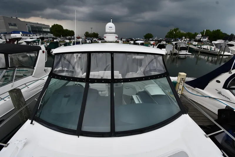 Slide: The Image of 2019 Cruisers Yachts 380 Express docked at marina under stormy skies. - 8