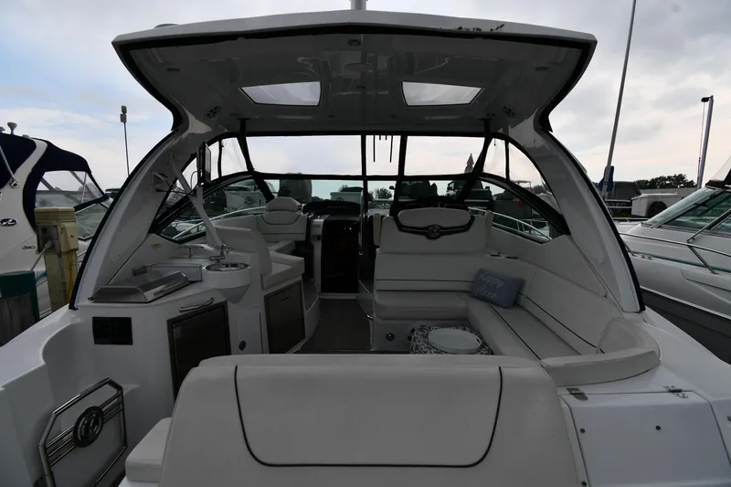 Slide: The Image of 2019 Cruisers Yachts 380 Express interior with seating and kitchenette. - 9