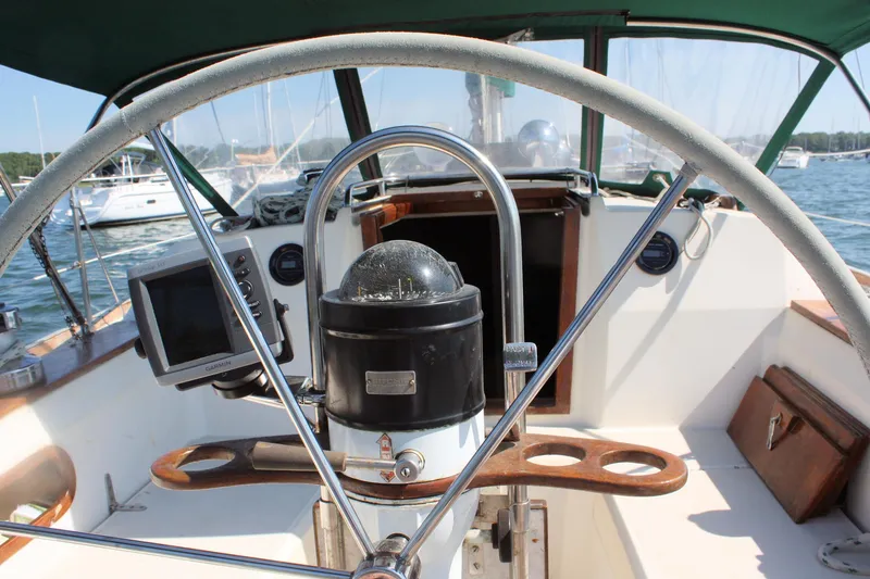 Slide: The Image of Cockpit view of 1986 Sabre 34 MK II sailboat with steering wheel and navigation equipment. - 11