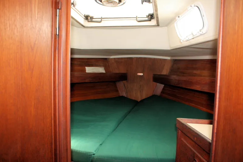 Slide: The Image of Cozy cabin interior of 1986 Sabre 34 MK II sailboat with green bedding. - 16