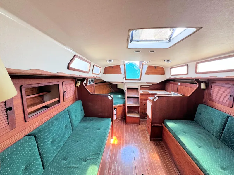 Slide: The Image of Interior of 1986 Sabre 34 MK II sailboat with green upholstery and wooden finishes. - 22