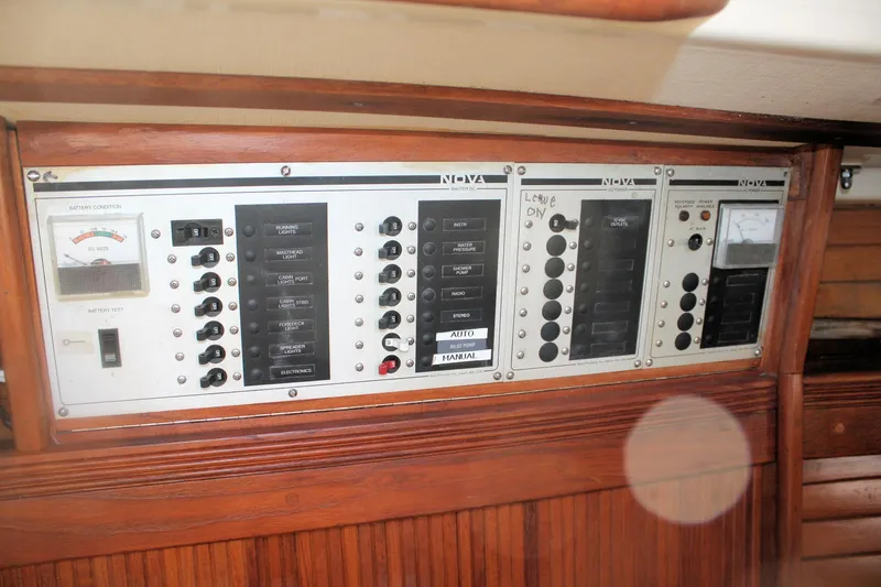 Slide: The Image of Electrical control panel on a 1986 Sabre 34 MK II sailboat, featuring switches and gauges. - 35