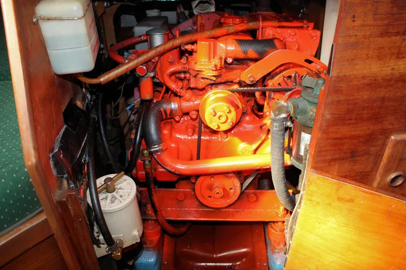 Slide: The Image of Engine compartment of a 1986 Sabre 34 MK II sailboat, featuring a bright orange engine. - 36
