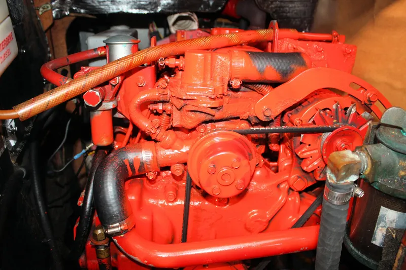 Slide: The Image of Bright red engine of a 1986 Sabre 34 MK II sailboat, showcasing mechanical components. - 38