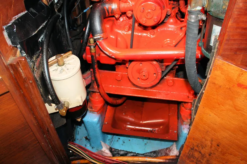 Slide: The Image of Engine compartment of a 1986 Sabre 34 MK II sailboat, featuring a red-painted engine. - 39