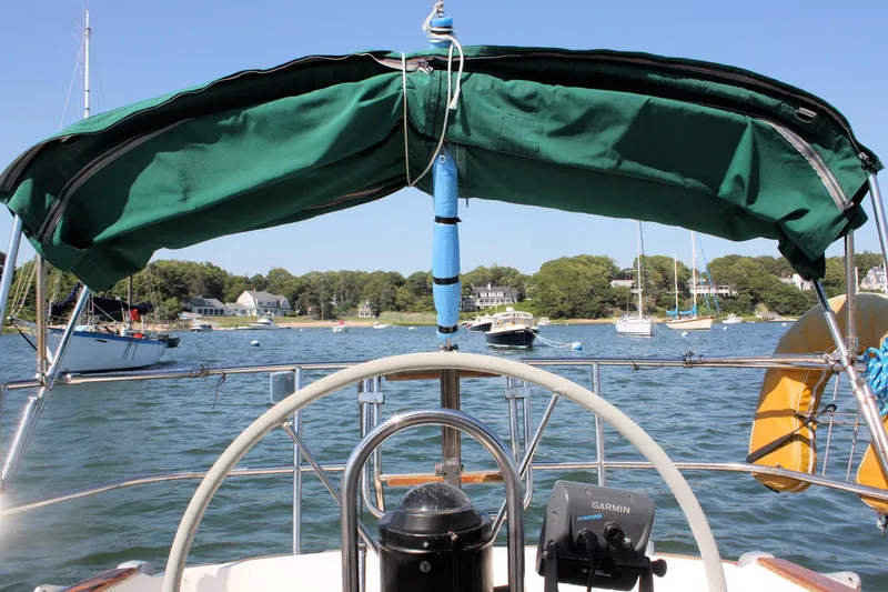Slide: The Image of 1986 Sabre 34 MK II sailboat cockpit view with green canopy on a sunny day. - 9