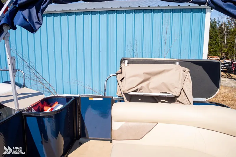 Slide: The Image of 2019 Crest CREST I 220 L pontoon boat interior with blue siding and beige seating. - 13
