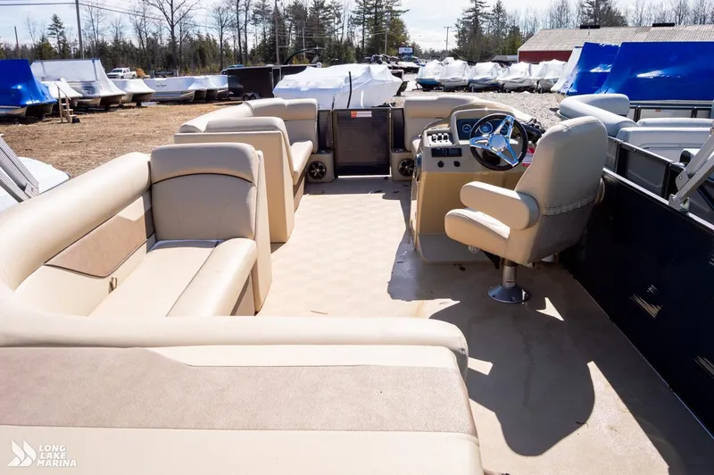 Slide: The Image of 2019 Crest CREST I 220 L pontoon boat interior with beige seating and steering console. - 3