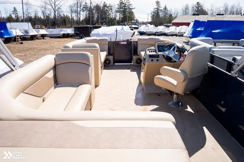 Slide: The Image of 2019 Crest CREST I 220 L pontoon boat interior with beige seating and steering console. - 6