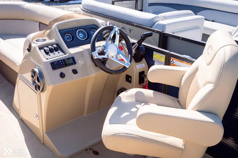 Slide: The Image of 2019 Crest CREST I 220 L boat interior with steering wheel and beige seating. - 7
