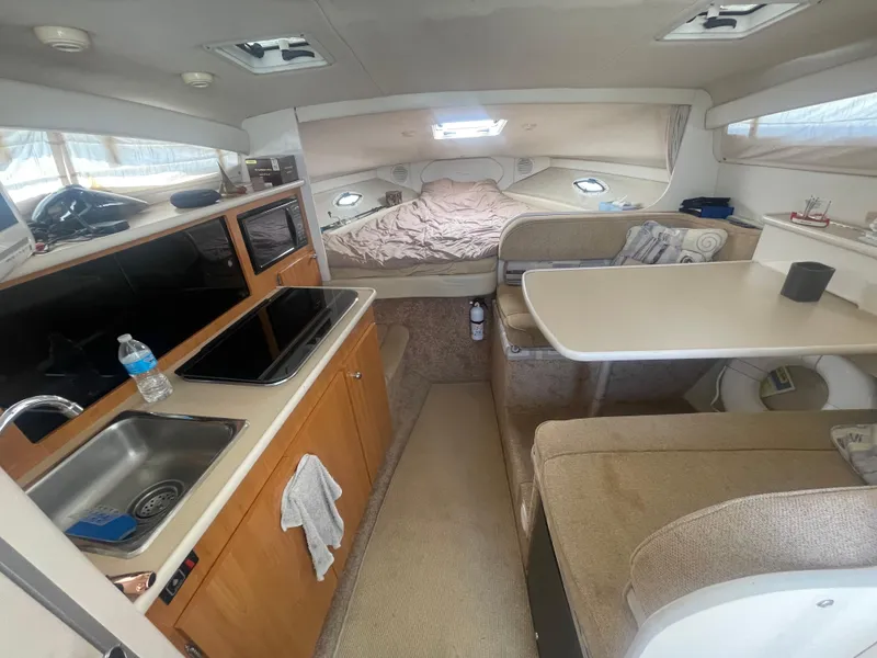 Slide: The Image of Interior of a 1989 Californian Express boat with kitchen and cozy sleeping area. - 13