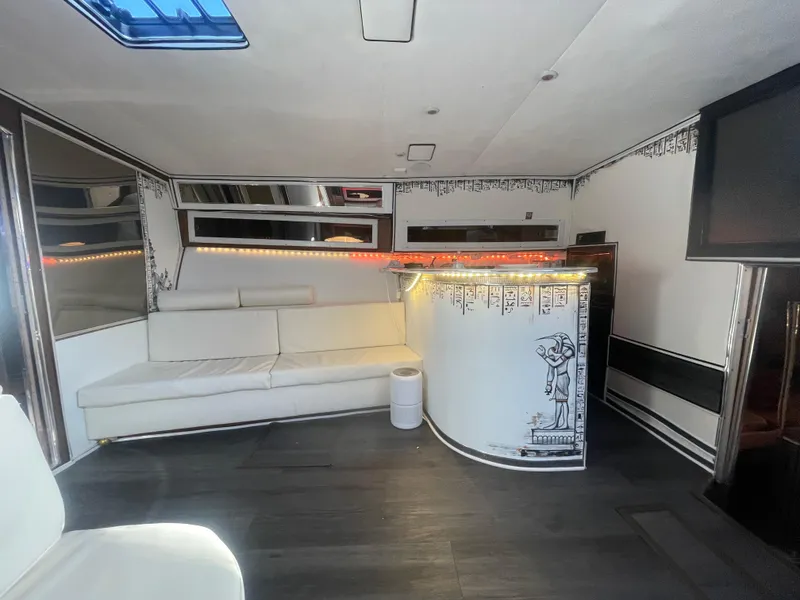 Slide: The Image of Luxurious 1989 Californian Express interior with white seating, bar, and Egyptian-themed decor. - 17