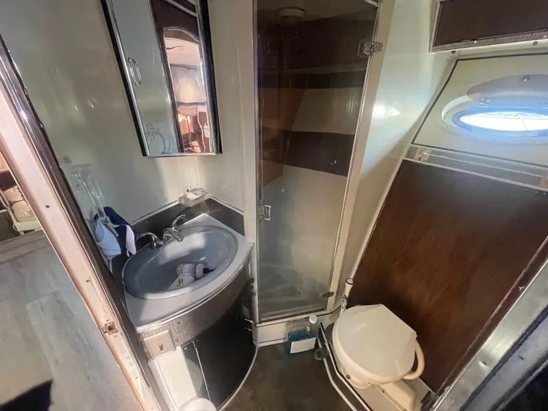 Slide: The Image of Compact bathroom in 1989 Californian Express boat with sink, toilet, and shower. - 18