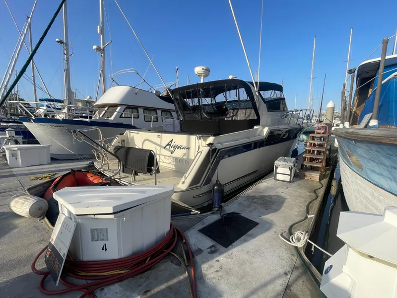 Slide: The Image of 1989 Californian Express yacht docked at marina, surrounded by other boats. - 2