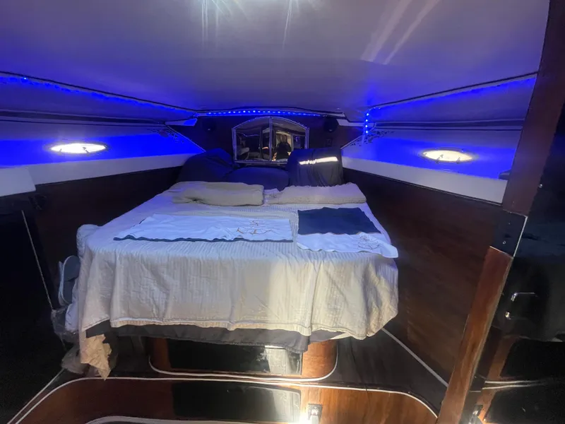 Slide: The Image of Cozy cabin interior of 1989 Californian Express boat with ambient blue lighting. - 22