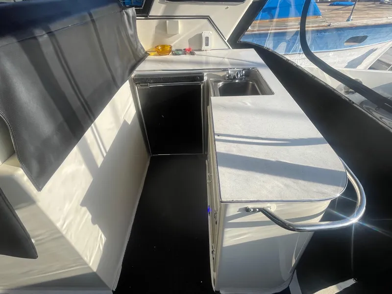 Slide: The Image of Compact kitchen area in a 1989 Californian Express boat, featuring a sink and countertop. - 25