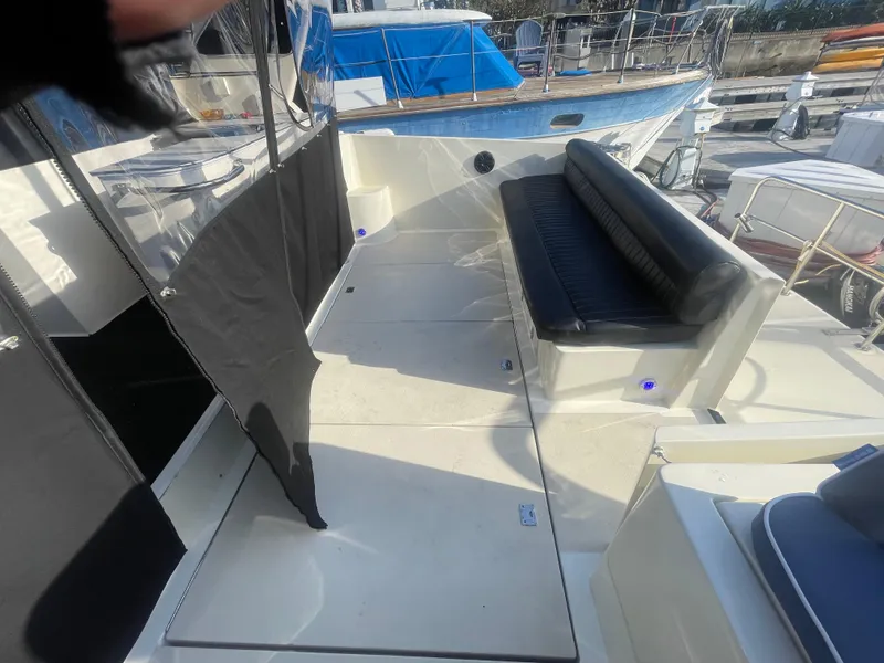 Slide: The Image of 1989 Californian Express boat deck with black seating and protective covers. - 26