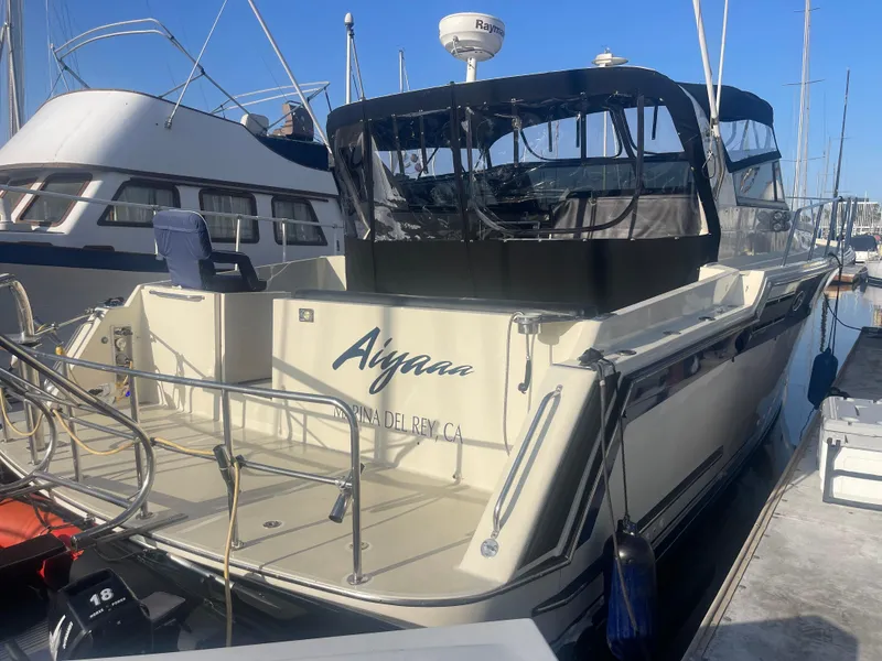 Slide: The Image of 1989 Californian Express boat docked at Marina del Rey, featuring a sleek design and covered deck. - 28