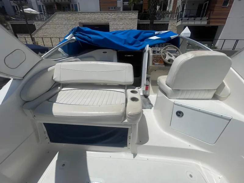 Slide: The Image of 1989 Californian Express boat interior with white seating and blue cover. - 7