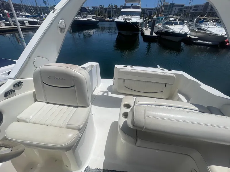 Slide: The Image of 1989 Californian Express boat interior with white seating, docked at marina. - 8