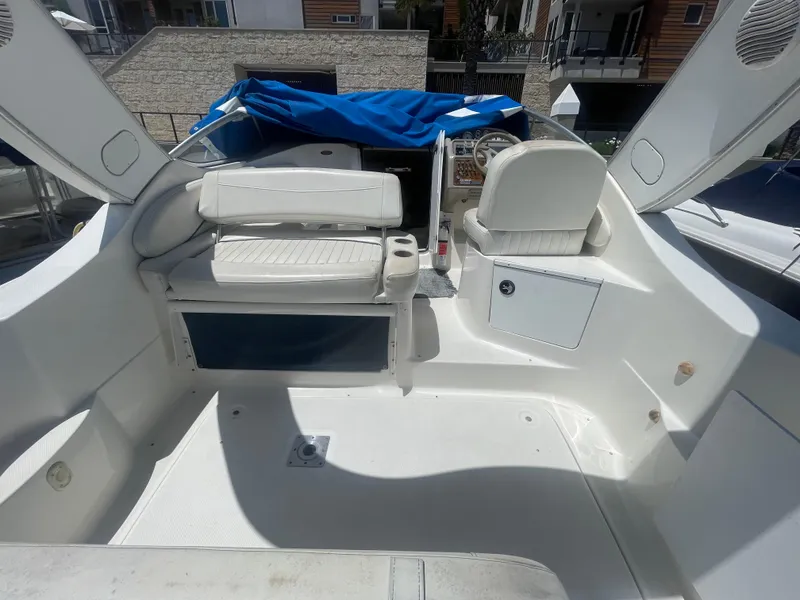 Slide: The Image of 1989 Californian Express boat interior with white seating and blue cover. - 9