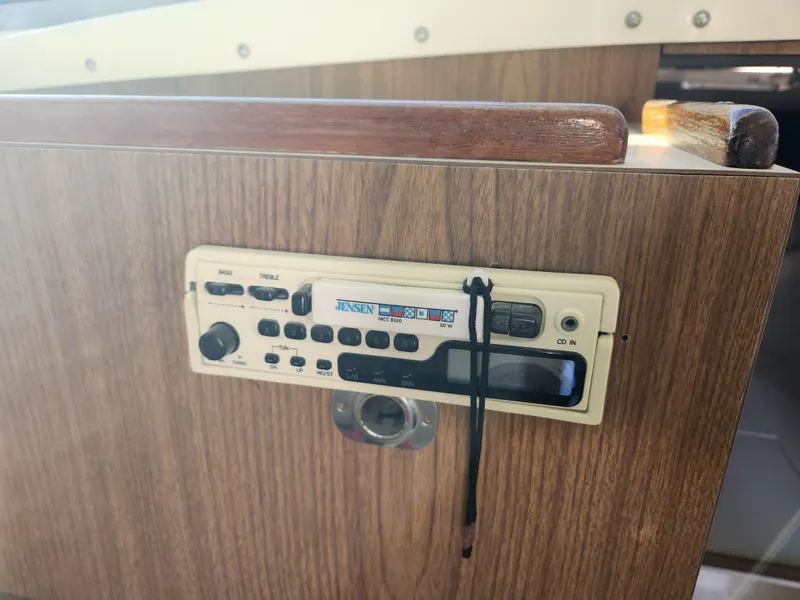 Slide: The Image of 1975 Bertram 28 Flybridge Cruiser radio panel with wood finish. - 13