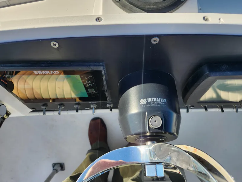 Slide: The Image of 1975 Bertram 28 Flybridge Cruiser helm with Ultraflex steering and Simrad electronics. - 18