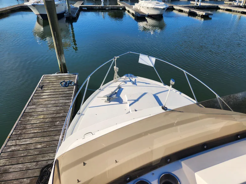 Slide: The Image of 1975 Bertram 28 Flybridge Cruiser docked at marina, viewed from flybridge. - 2