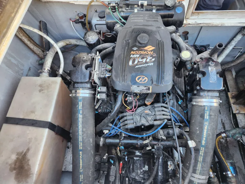 Slide: The Image of Engine compartment of a 1975 Bertram 28 Flybridge Cruiser with visible components and wiring. - 23
