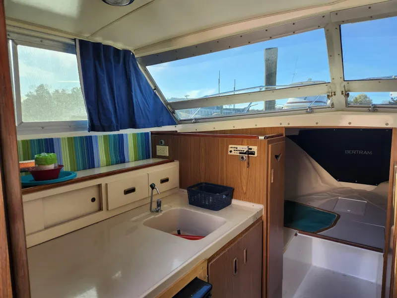 Slide: The Image of Interior of 1975 Bertram 28 Flybridge Cruiser with kitchenette and cozy cabin space. - 4