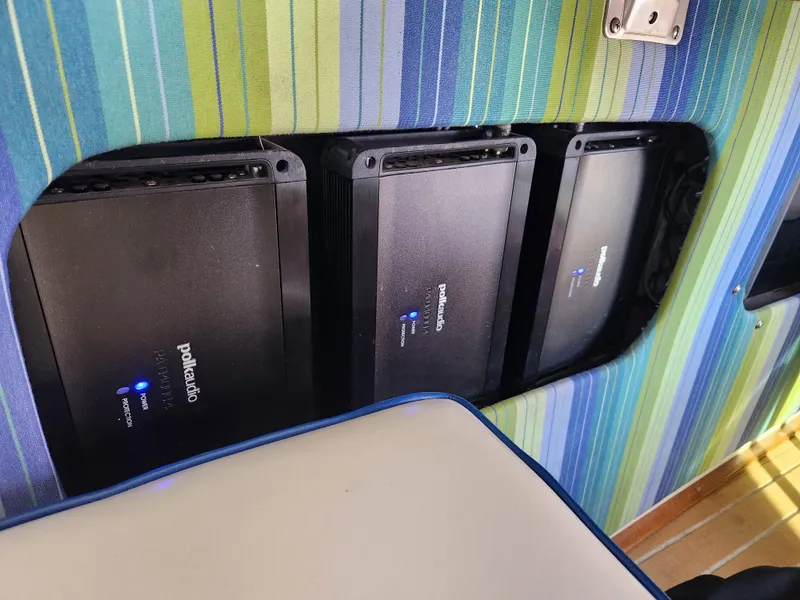 Slide: The Image of Power amplifiers installed in a 1975 Bertram 28 Flybridge Cruiser, against a striped background. - 7